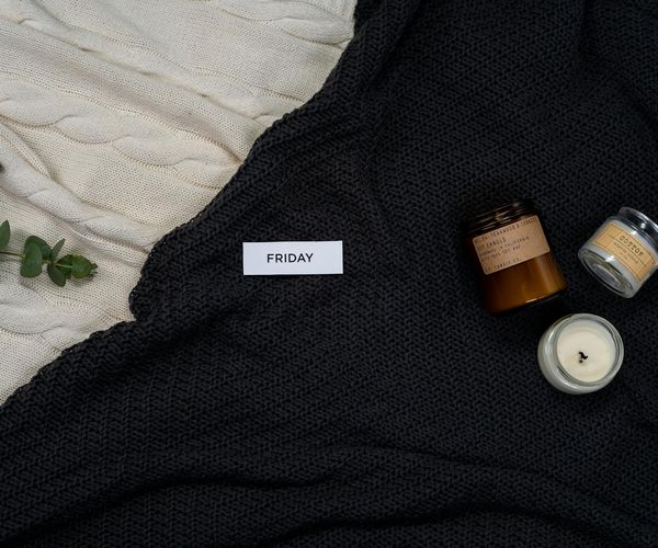 A cozy corner with a yoga mat, a candle, and soft blankets.